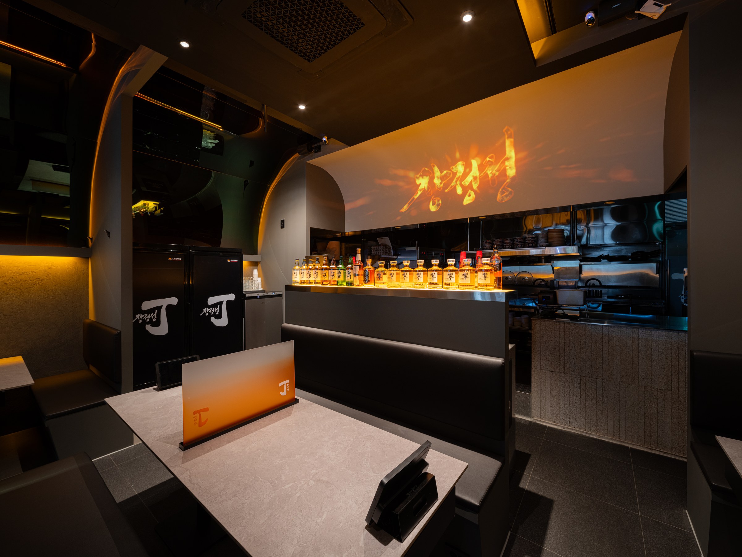 Open kitchen and moving image of fire forming the visual centre