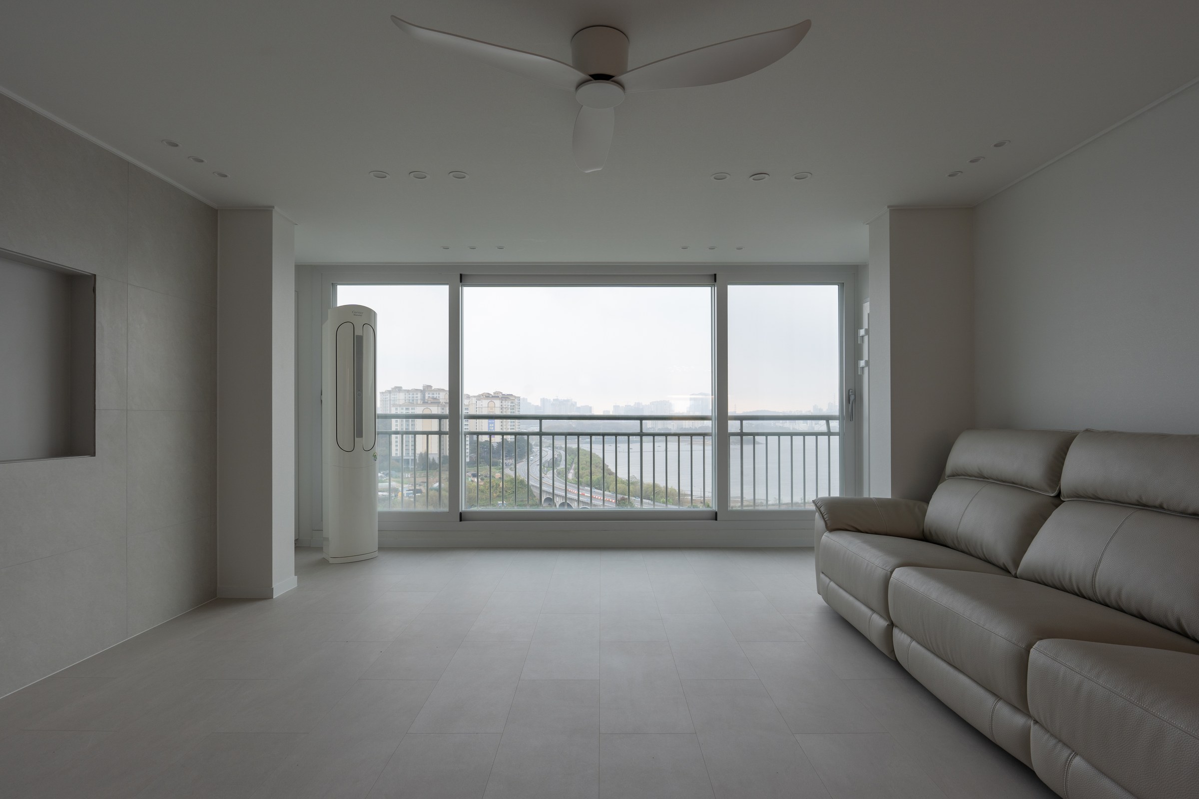 Living room kept open towards the large lake-facing window