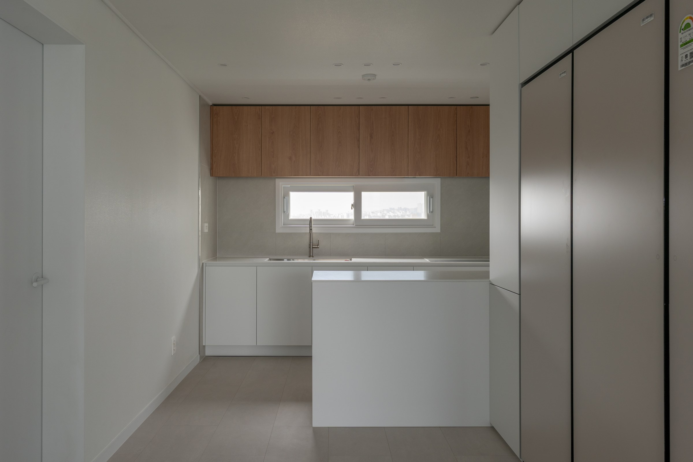 Kitchen elevation combining bright storage and timber upper cabinets